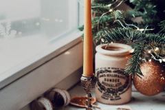 free-photo-of-a-candle-and-ornaments-on-a-window-sill